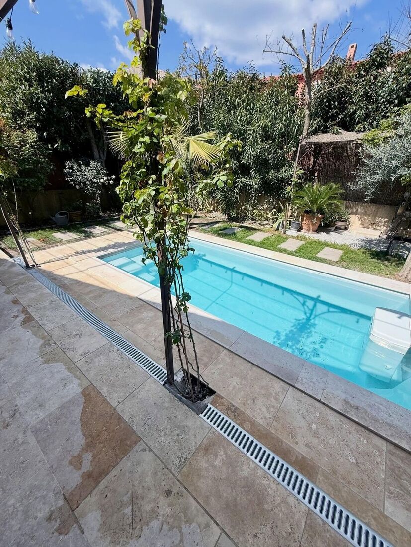 Prolongement de terrasse en travertin aux abords de piscine